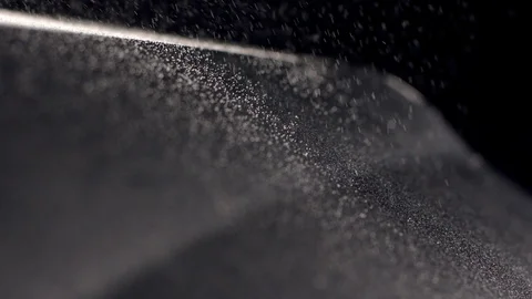 Particle falling down on black ground Stock Footage 108849966