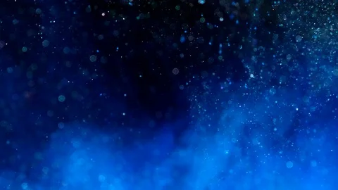 Particles of blue bioluminescent ink flowing in liquid water with bokeh Stock Footage