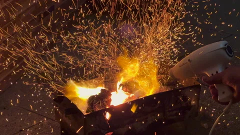 Particles of burning coal fire flames jump up with red flakes Stock Footage 201034856