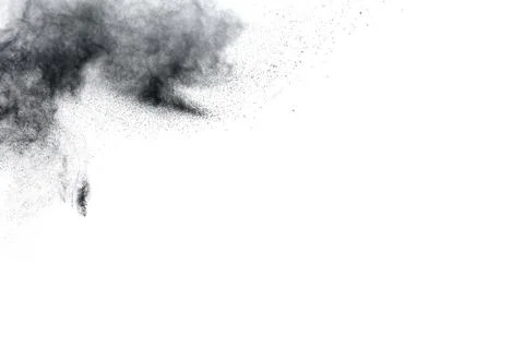The particles of charcoal splatted on white background. Stock Photos