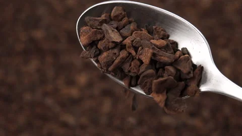 Particles of dried roasted chicory root fall from a teaspoon Stock Footage 152147542