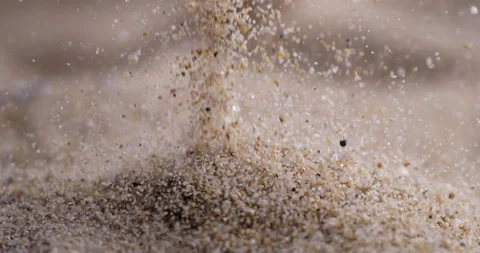Particles of dry sand is pouring down forming hill at 1000 fps Stock Footage 269908411