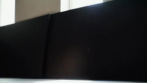 Particles of dust fall on a dark black, black background in gym, kids training  Stock Footage 240391307