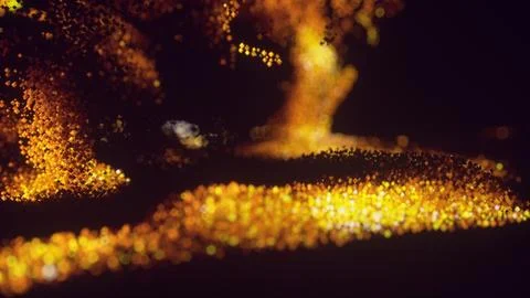 Particles move and cluster in a dark space forming a glowing fire-like shape Stock Photos