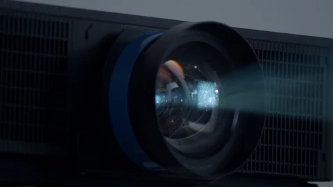 Particles swirl in light beam from projector lens, close-up Stock Footage 123807778