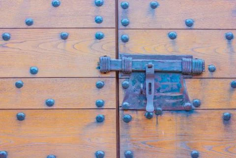 Particular of the door of a castle with its clapper Stock Photos