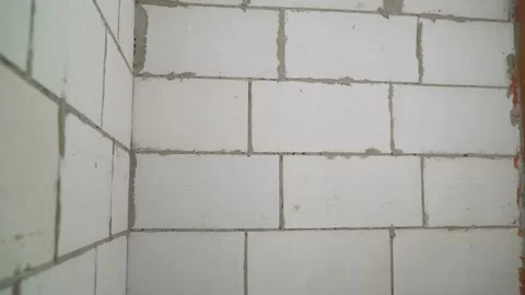 Partition wall made of cellular white block. Block wall in a new high-rise Stock Footage 157054445