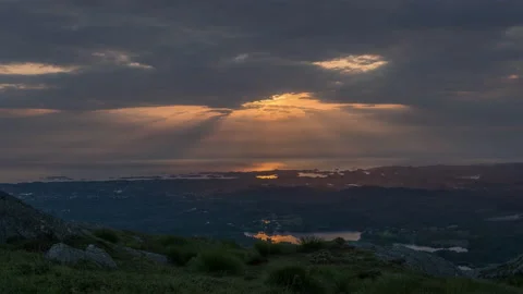Partly cloudy with god rays through clouds at mountain top - Timelapse 4K+ Stock Footage 138535794