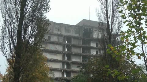 Partly demolished tower block through poplar trees Stock Footage 14815466