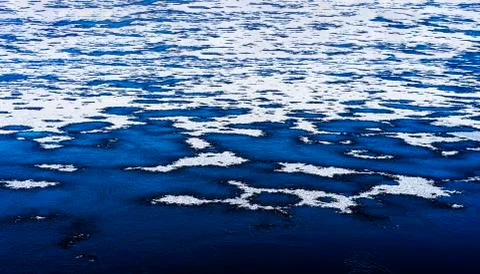 Partly frozen lake in winter time Stock Photos