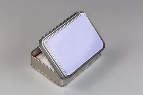 Partly open tin box to store various small household items Foto stock