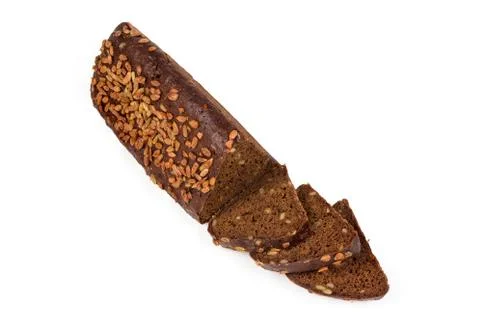 Partly sliced brown bread triangular shape sprinkled with sunflower seeds Stock Photos
