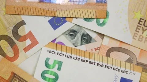 Partly view of 100 dollars bill from under euro banknotes Video stock 140360922