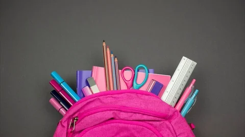 Partly view backpack with sticking out school supplies. Stop motion Video stock 113635137
