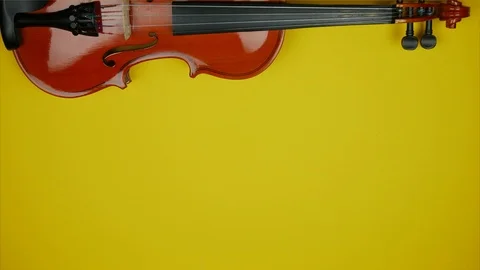 Partly view of violin on yellow background. Stop motion animation Stock Footage 99004942