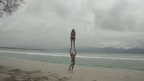 Partner Acrobatics on the Beach Slow Motion Stock Footage 106784775
