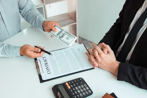 Partner has made a fraud in the contract of sale and being handed a cash an.. Stock Photos