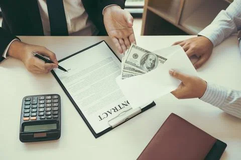 Partner has made a fraud in the contract of sale and being handed a cash an.. Stock Photos