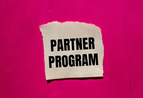 Partner program message written on ripped torn paper piece on pink background Stock Photos