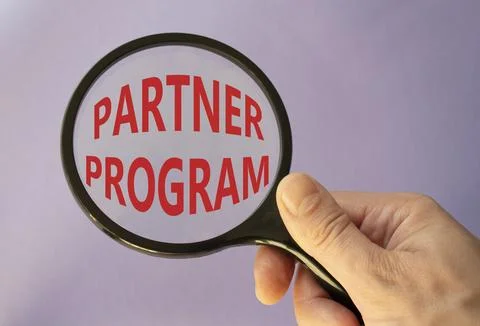 Partner Program symbol. Concept words Partner Program on magnifying glass. .. Stock Photos