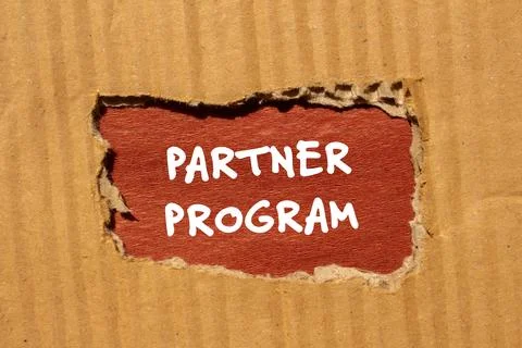Partner program words written on ripped paper with brown background Stock Photos
