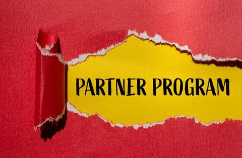 Partner program words written on ripped red paper with yellow background. Con Stock Photos