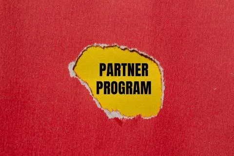 Partner program words written on ripped red paper with yellow background. Con Stock Photos