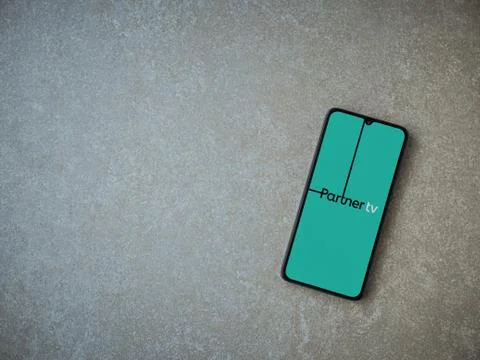Partner tv app launch screen with logo on the display of a black mobile smart Stock Photos