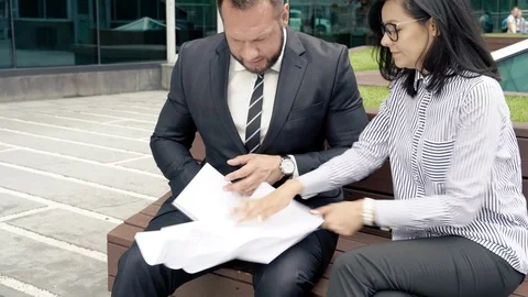 Partners arguing about mistake in document, throwing papers and cursing Stock Footage 111759569