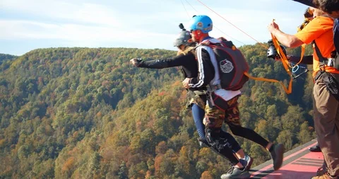 Partners Base Jumping Off Bridge, Parachute Pull, Slow Motion Stock Footage 127466664