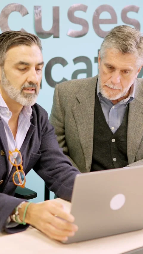 Partners discussing while using laptop in a meeting room Stock Footage 269748089