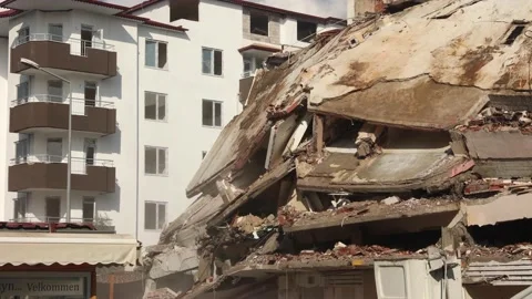 Parts of house fall down during demolition of building, old building being Stock Footage 225075397