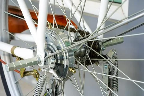 Parts of rear metal chain and gearshift in the white bicycle, the power from  Stock Photos
