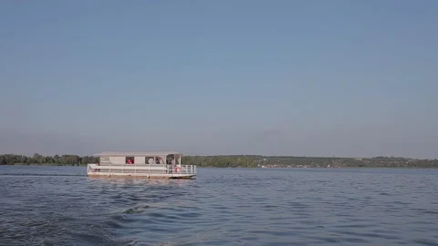 Party boat floats on the river at sunset. Party boat at sunset. Pleasure boat Stock Footage 202000432