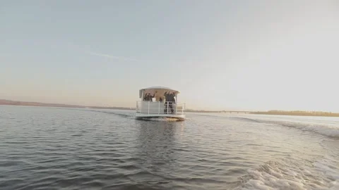 Party boat floats on the river at sunset. Pleasure boat for parties. Party boat Stock Footage 202000479