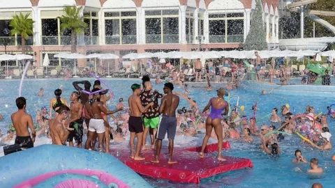 Party dancing summer in hotel’s refreshing pool, people have fun and dance. Stock Footage 123308792
