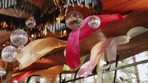 Party decor using disco balls and wavy fabrics everywhere. Restaurant terrace Stock Footage 324674052