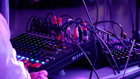 Before a party: knobs and faders of a DJ mixer console. The hands of a man 動画素材 248192506