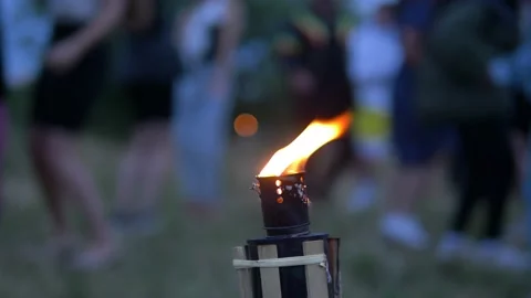 Party outside - Young people dancing, close up torch in foreground Video stock 149753310