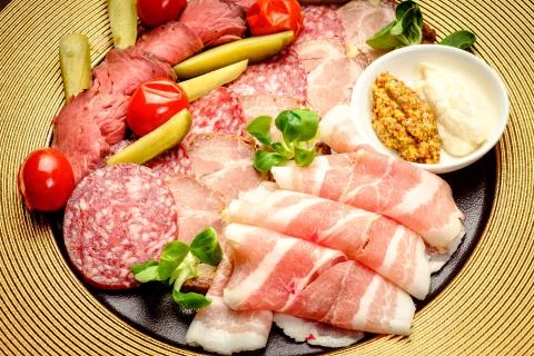 Party Platter of Assorted Cured Meats with sauce and pickles Stock Photos