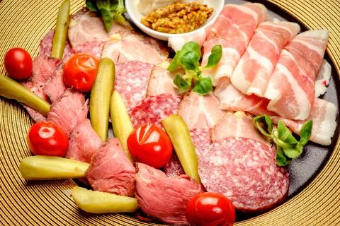 Party Platter of Assorted Cured Meats with sauce and pickles Stock Photos
