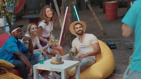 Party time. Group of cheerful young men and women posing and smiling on camera Stock Footage 114928596
