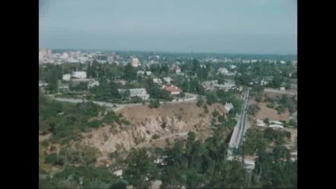 PASADENA - 1950s - Aerial view of the Pasadena skyline, highway roads and San Stock Footage 340582388
