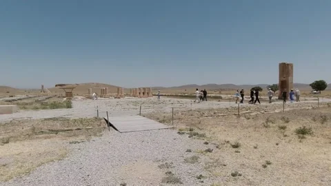 Pasargadae stone columns and palace foundations under midday sky Stock Footage 320460692
