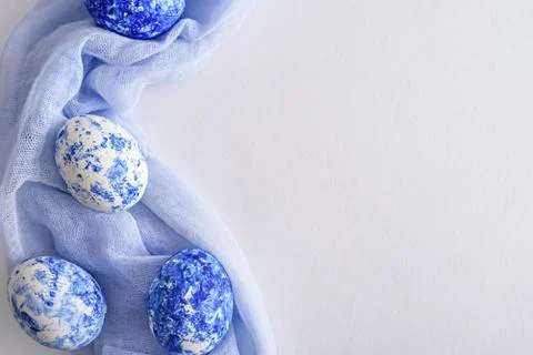 Paschal eggs with effect of classic blue gradient laid out on pale blue napki Stock Photos