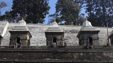 Pashupatinath: people sitting on the steps of the complex Stock-Footage 58560860