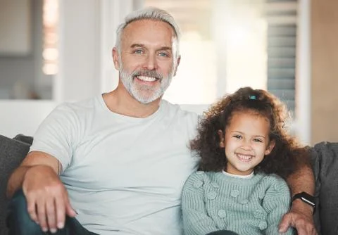 Pass along the value of empathy to our children. a girl sitting at home with her Stock Photos