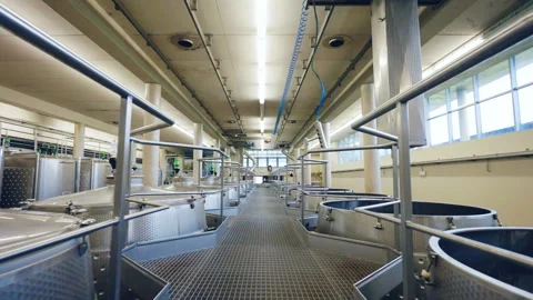 Pass between the rows of stainless clean tanks for wine production, metal Video stock 296758404