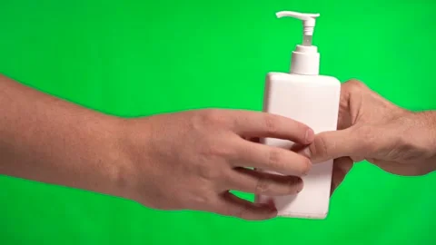 Pass Hand to Hand Bottle of Hand Antiseptic Gel. Slow motion. Chromakey Green Stock Footage 145196508