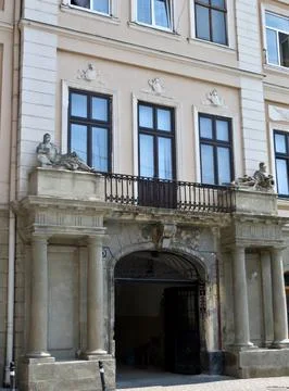 Passage with arch through the old building. On the columns there are stone .. Stock Photos